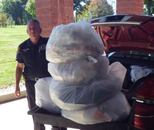 Detective Sean Lewis from the Yorktow Police Department takes 130 pounds of drugs for disposal.